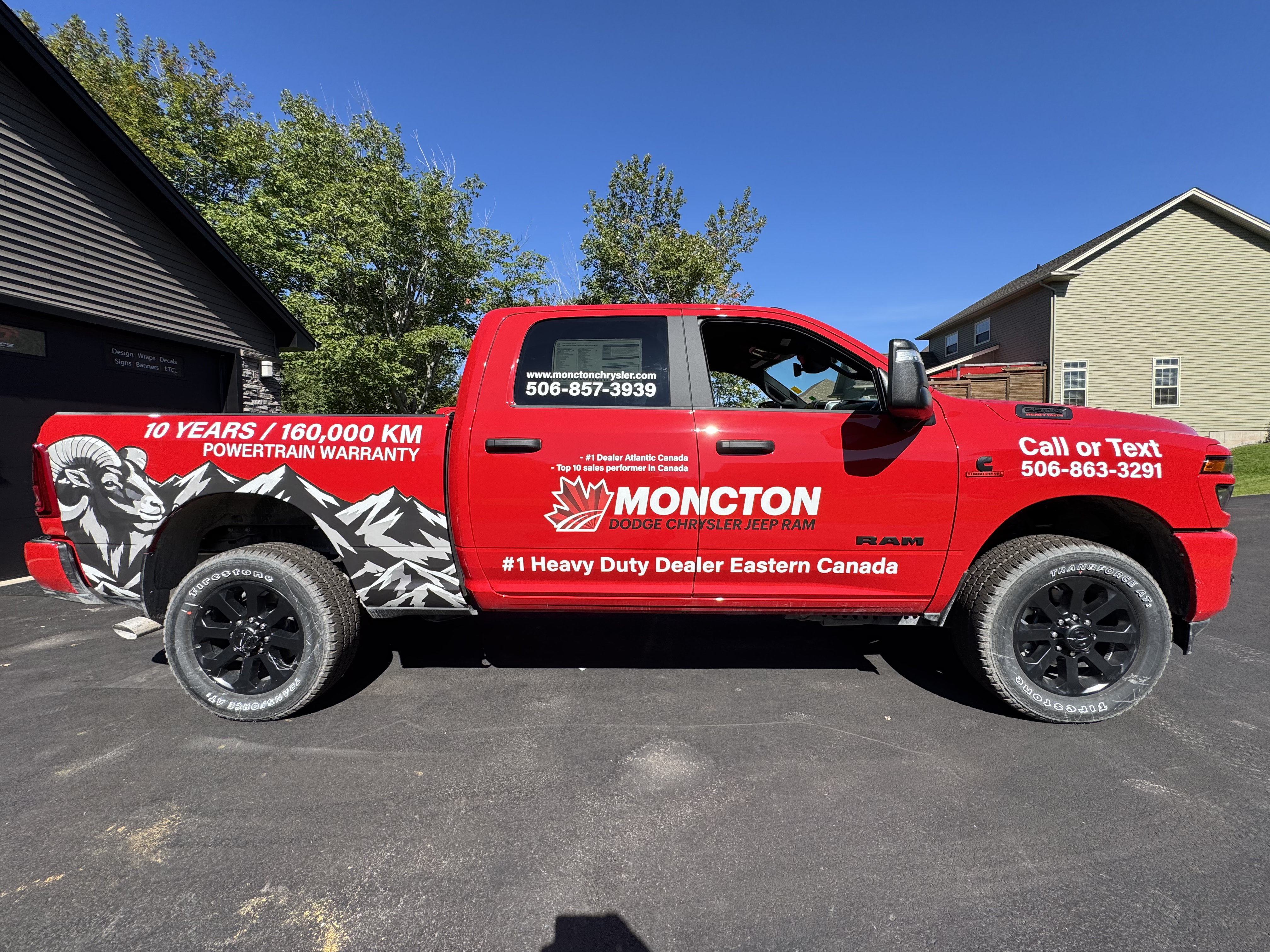 Red Moncton Chrysler truck with full custom business graphics