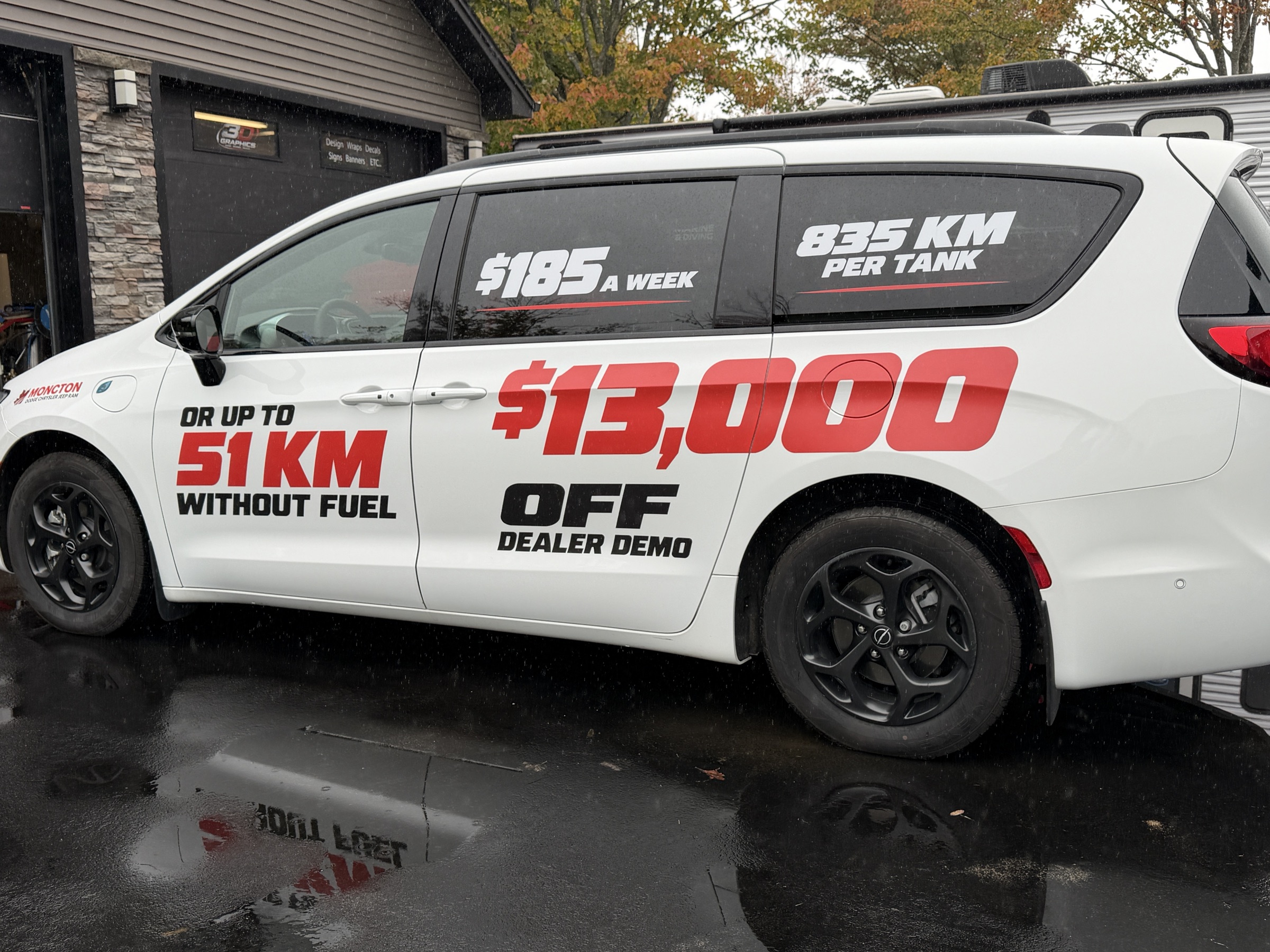 White dealership SUV with bold promotional vinyl graphics
